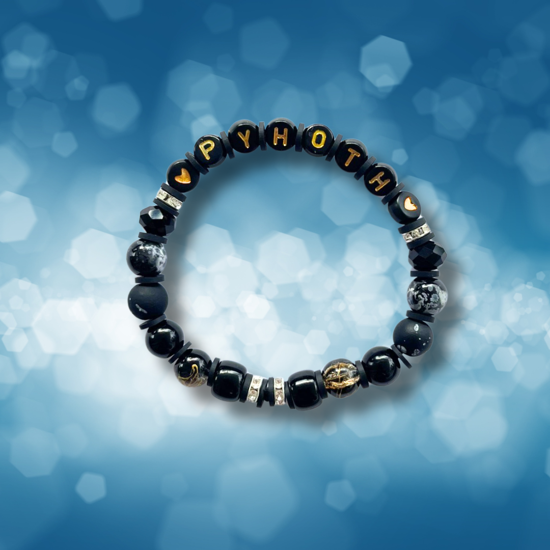 Black beaded bracelet with the letters PYHOTH, on a blue background.